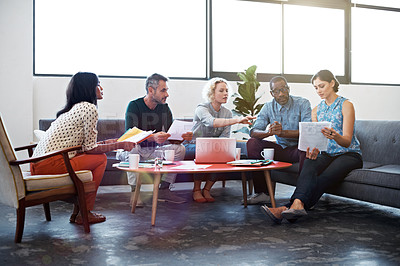 Buy stock photo Shot of a group of coworkers talking together in a modern office