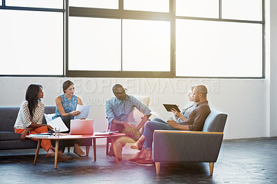 Buy stock photo Shot of a group of coworkers talking together in a modern office