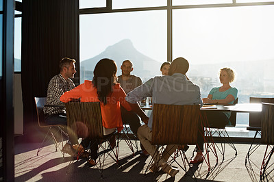 Buy stock photo Shot of a group of colleagues having a meeting together in a boardroom
