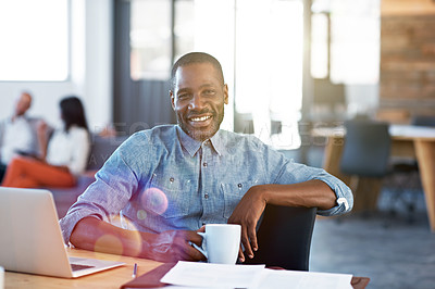 Buy stock photo Portrait of a smiling man sitting at his desk in an office with colleagues in the background