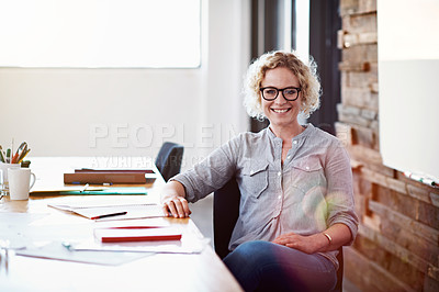 Buy stock photo Portrait of a confident young professional sitting at her desk in an office