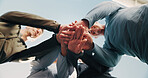Blue sky, senior people and hands with huddle for fitness, support and celebration together. Nature, retirement and friends with stack for solidarity, exercise goal or motivation with low angle