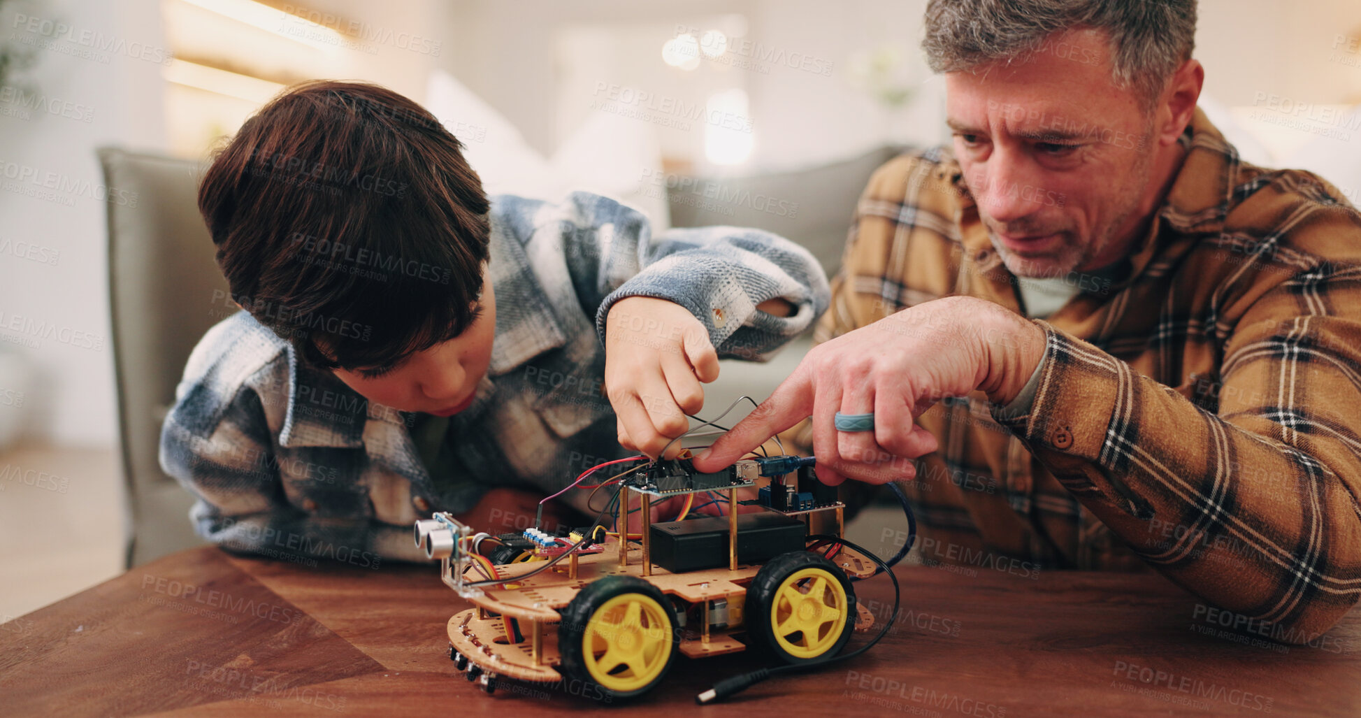 Buy stock photo Building, father or son in lounge with toy car, craft play or parent help with robotics activity. Connection, dad or boy in home with prototype, family support or bonding together with mechanic hobby