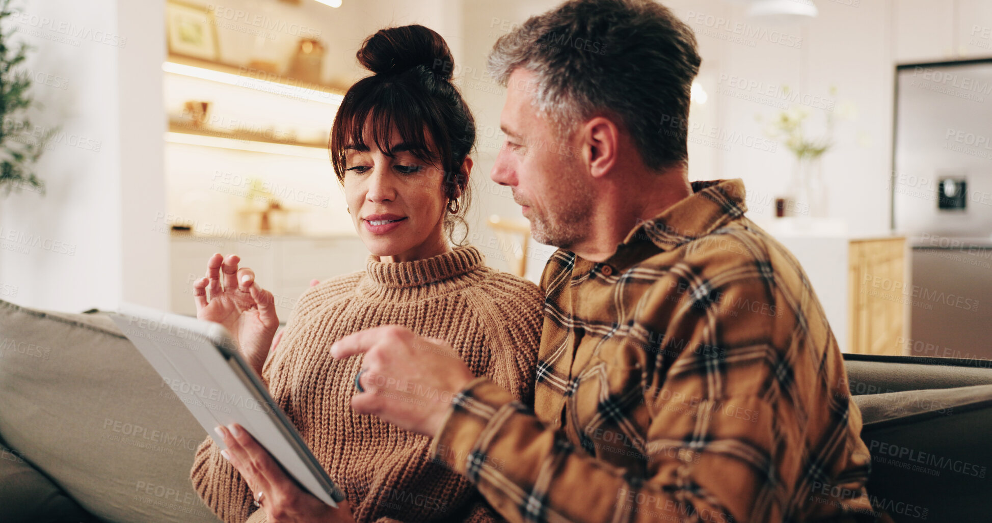 Buy stock photo Talking, sofa and couple on tablet for planning, online shopping and decision for purchase. Marriage, home and man with woman on digital tech for connection, internet and bonding for relationship