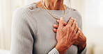 Senior, woman and hands with chest pain in home for cardiac arrest, respiratory infection or disease. Elderly, female person or patient with heart ache, chronic stress or high blood pressure in house