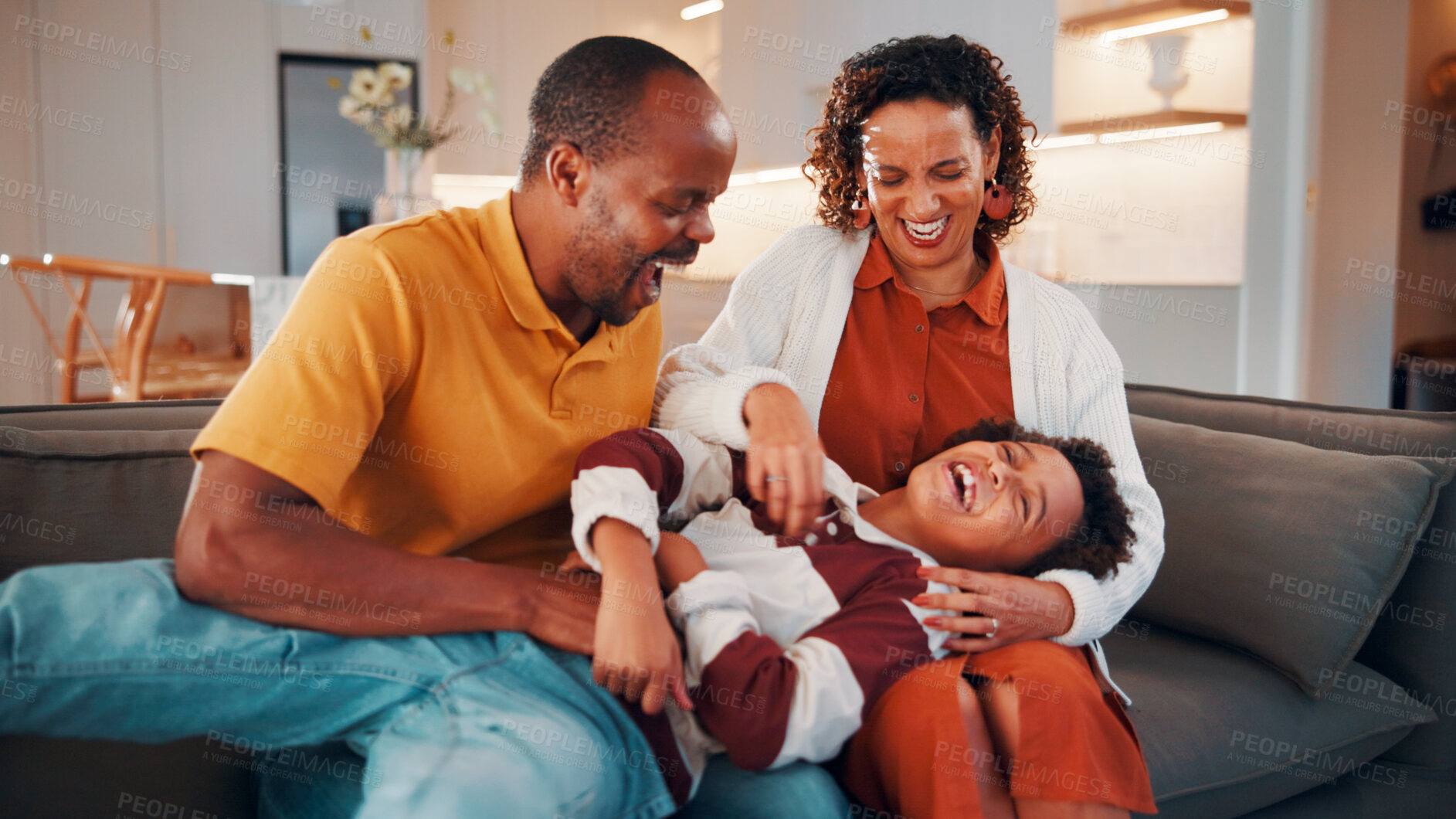 Buy stock photo Parents, laugh and tickle child in home with family bonding together, love or humor on weekend break. Happy African people, mother and father play on sofa with son, care or funny joke for connection.