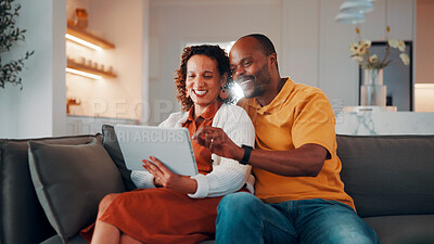 Buy stock photo Couple, online and laughing with tablet in house, love or streaming film with subscription in lounge. Entertainment, home and mature African people with tech for funny movie, rest and bonding on sofa