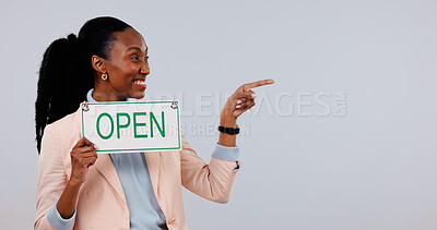 Buy stock photo Happy, space and black woman with open sign in studio for business welcome, advertising or marketing. Pointing, poster and employee with options, menu or list for service on white background.
