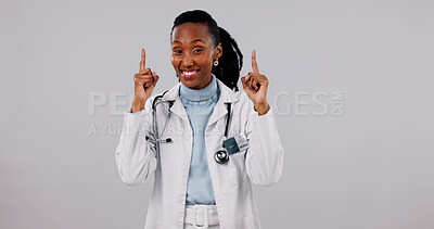 Buy stock photo Happy, pointing and portrait of doctor in studio for medical service, health support and mockup. Healthcare, space and black woman with news for announcement, medicare or wellness on white background