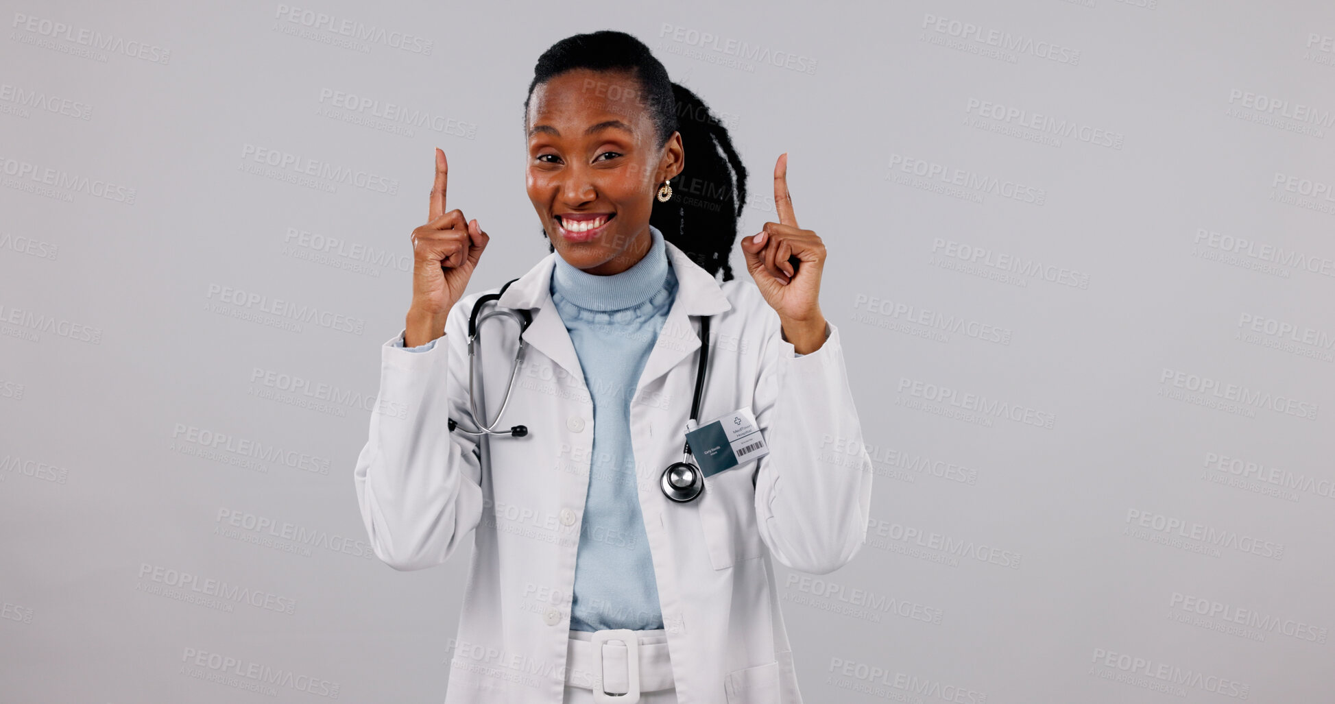 Buy stock photo Happy, pointing and portrait of doctor in studio for medical service, health support and mockup. Healthcare, space and black woman with news for announcement, medicare or wellness on white background