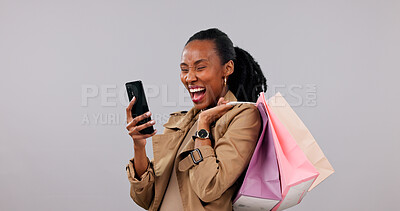 Buy stock photo Studio, shopping bags and woman with phone, laughing and good news on social media and notification. White background, customer and black person with mobile, space and happy for discount offer on web