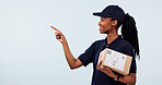 Pointing, space and woman in studio for delivery, shipping and advertising for courier service. Mockup, happy and African person with box for ecommerce, logistics and information on white background