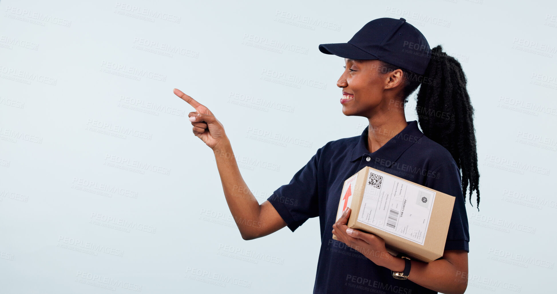 Buy stock photo Pointing, space and woman in studio for delivery, shipping and advertising for courier service. Mockup, happy and African person with box for ecommerce, logistics and information on white background