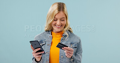 Buy stock photo Happy, girl and credit card with phone in studio for app subscription, online shopping and fintech. Mockup space, person and mobile banking on blue background for digital wallet, checkout or payment