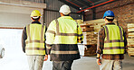 Woodworking, teamwork and men with helmet in factory, walking or inspection for furniture production. Carpenter, quality assurance and people with hard hat, back and manufacturing project in workshop