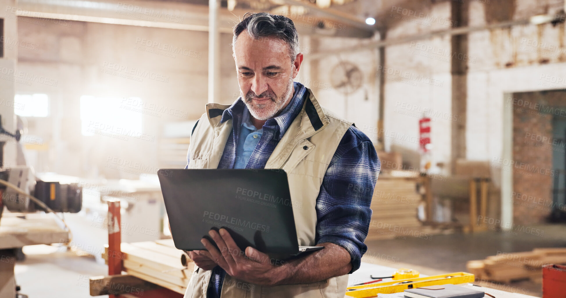 Buy stock photo Laptop, carpenter and man in workshop for planning, online order and inventory report for furniture project. Carpentry, mature and person on computer for woodworking, production and timber business