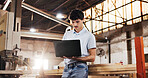 Laptop, carpenter and man in workshop for online report, planning or inventory for furniture project. Carpentry, factory and person on computer for woodworking, production schedule or timber business