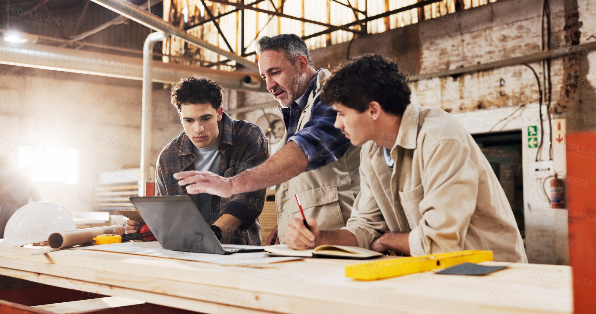 Buy stock photo Carpenter, team and laptop in warehouse for planning, project management and help for apprentice. Men, tech and discussion in woodworking factory for collaboration, tips and productivity with manager