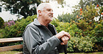 Thinking, outdoor and senior man on bench with reflection, fresh air and thoughtful for wellness. Retirement, nature and person with walking stick, nostalgia and memory for peace, calm and relax