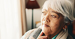 Thinking, serious and senior woman by window in home with memory, remember or planning retirement. Pension, decision and elderly person in living room with choice, reflection or nostalgia in house.