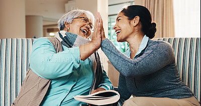 Buy stock photo Caregiver, old woman and high five with book for games, word search and encourage for crossword. Smile, nurse and senior person in home with sudoku, answer success and achievement for puzzle activity