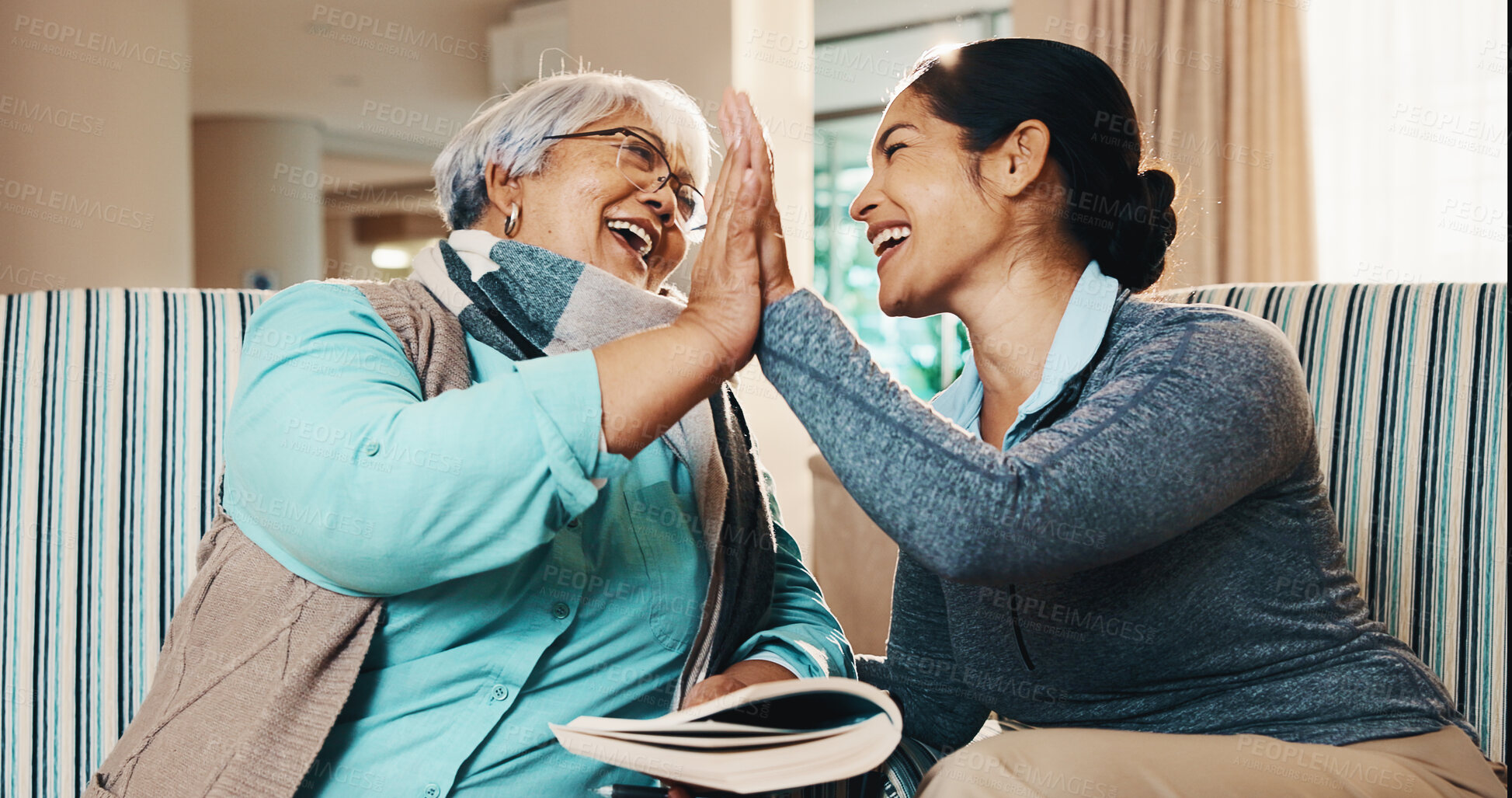Buy stock photo Caregiver, old woman and high five with book for games, word search and encourage for crossword. Smile, nurse and senior person in home with sudoku, answer success and achievement for puzzle activity