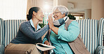Caregiver, old woman and high five at house with book, word search and encourage for crossword. Smile, nurse or senior person in lounge with sudoku, answer success and achievement for puzzle activity