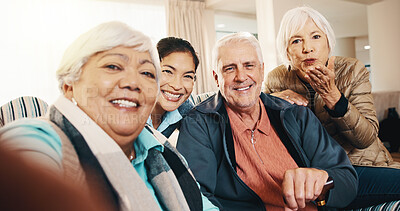 Buy stock photo Caregiver, home and selfie with elderly people, portrait and blow kiss for social media. Happy carer, friends and picture in living room in retirement, photography and POV with memory in homecare