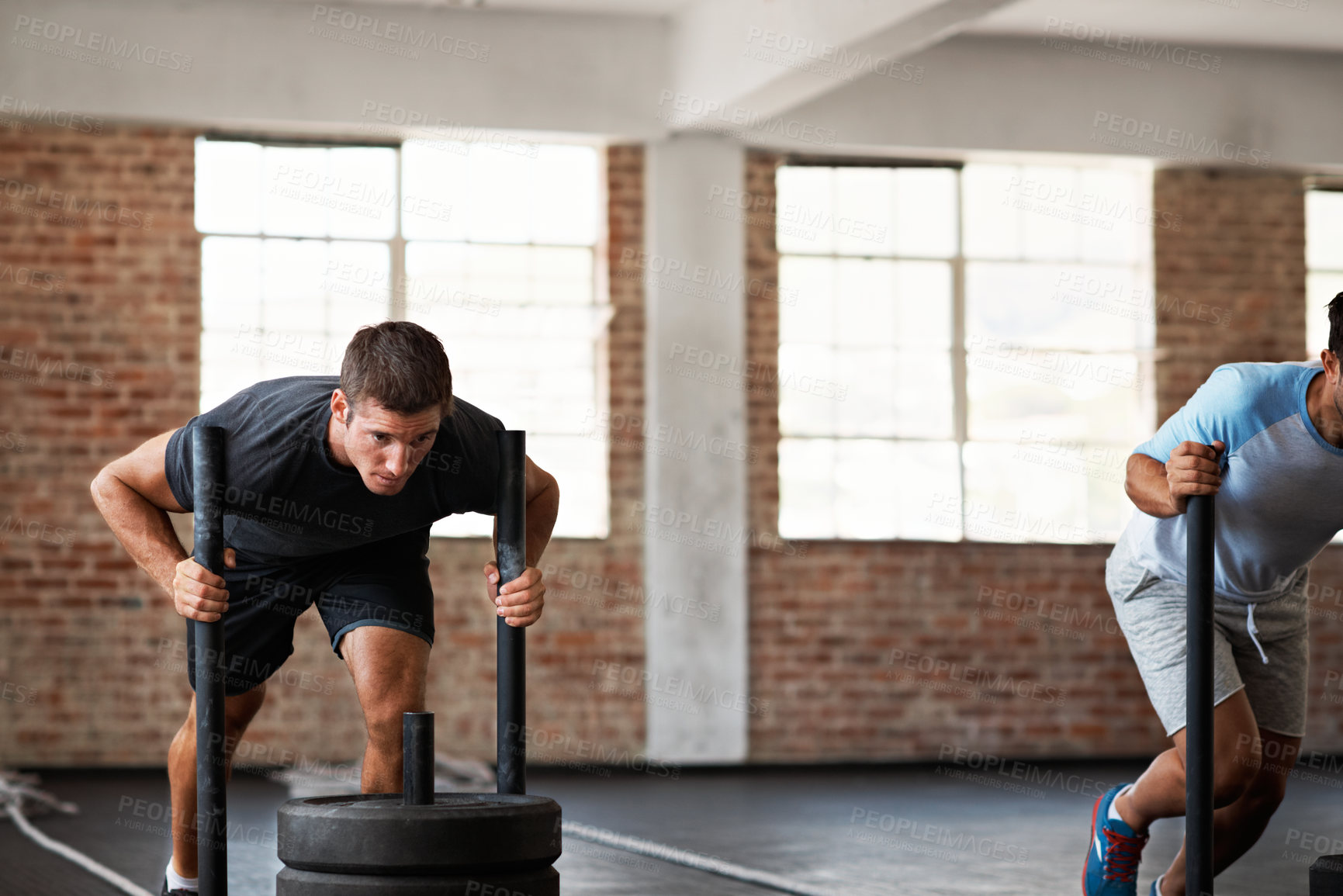 Buy stock photo Gym, men and weight sled for fitness, functional training and physical conditioning for strength. Athlete, HIIT class and prowler push for power workout, endurance challenge and resistance exercise
