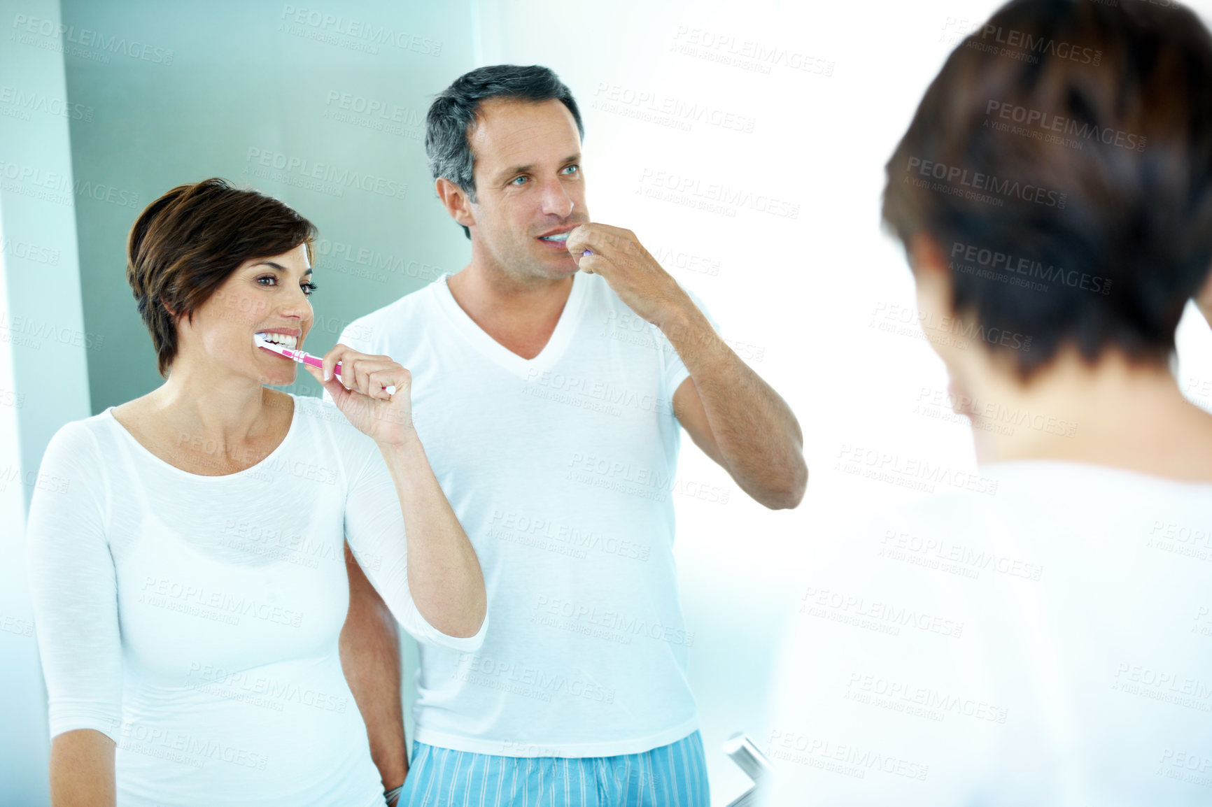 Buy stock photo Couple, mirror and cleaning with toothbrush for dental care, grooming and morning routine in home. Mature man, woman and reflection for brushing teeth, toothpaste and wellness in house bathroom