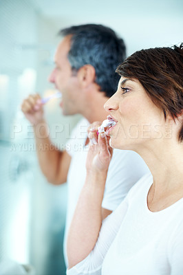 Buy stock photo Woman, hygiene and brushing teeth in bathroom for dental care, grooming and morning routine. Couple, enamel toothpaste and toothbrush for mouth, oral health and cleaning for fresh breath in house