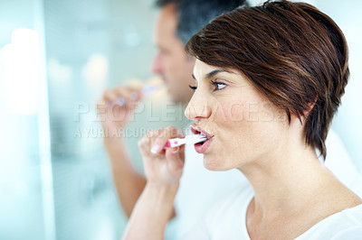 Buy stock photo Woman, cleaning and toothbrush in home for dental care, grooming and morning routine. Couple, toothpaste and mouth for brushing teeth, oral health and hygiene for fresh breath in house bathroom
