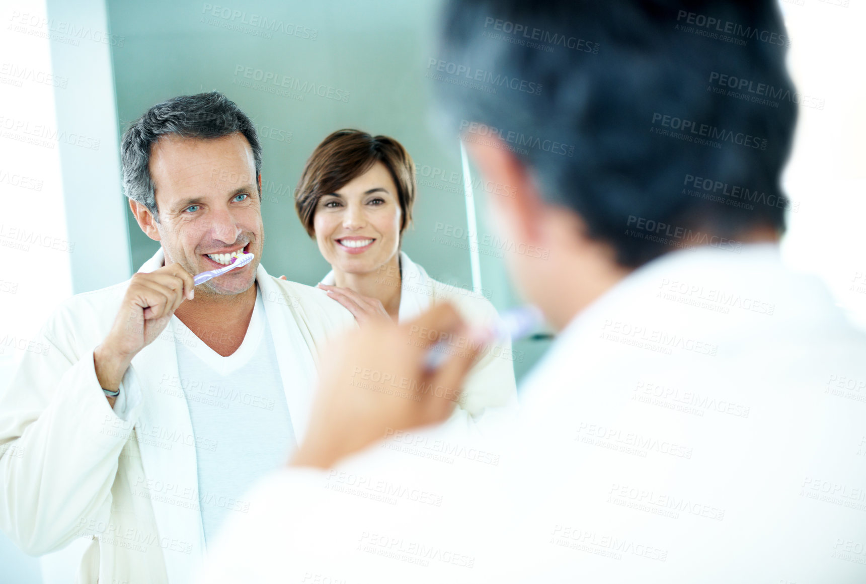 Buy stock photo Couple, mirror and toothbrush to clean for dental care, grooming and morning routine in home. Mature man, woman and smile for brushing teeth, love and wellness or happiness in house bathroom