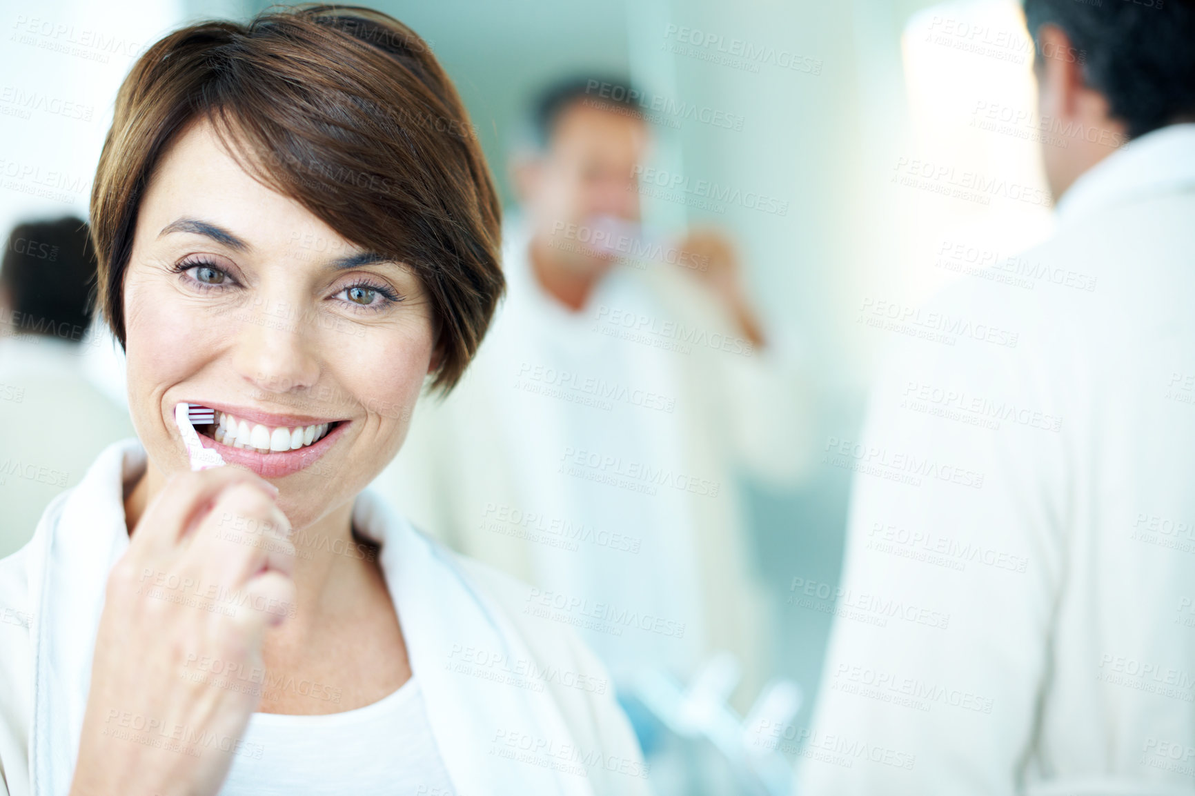 Buy stock photo Portrait, oral hygiene and happy woman in bathroom, brushing teeth or grooming with partner in home. Couple, smile and people with toothbrush for morning routine, dental care and wash mouth in house