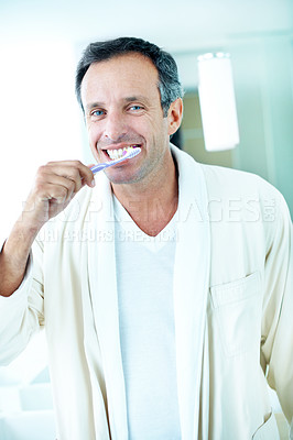 Buy stock photo Portrait, man and brushing teeth in bathroom with morning routine, dental hygiene and healthy habits. Happy, mature person and grooming in house with bathrobe, toothbrush and getting ready for day.