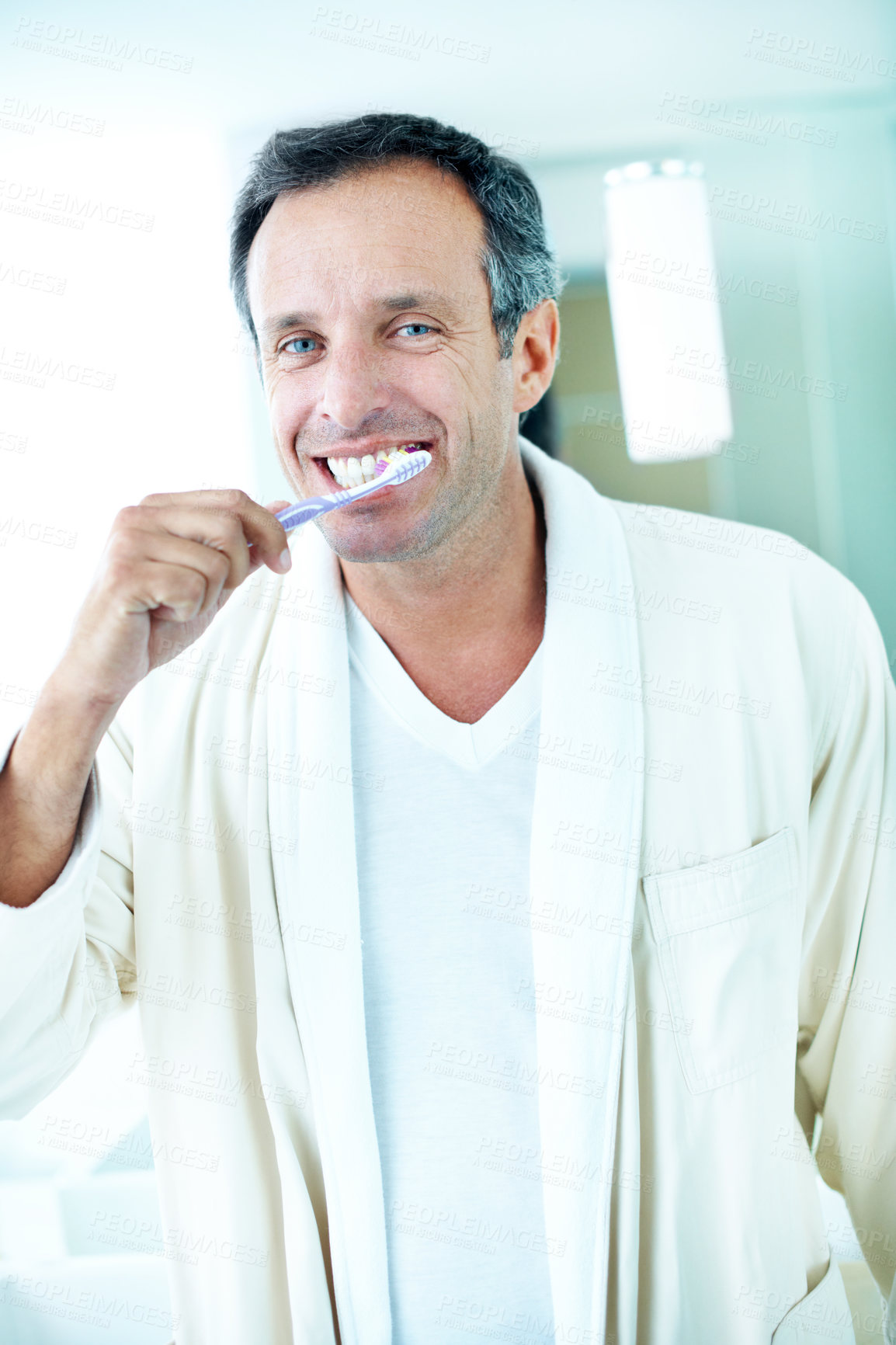 Buy stock photo Portrait, man and brushing teeth in bathroom with morning routine, dental hygiene and healthy habits. Happy, mature person and grooming in house with bathrobe, toothbrush and getting ready for day.