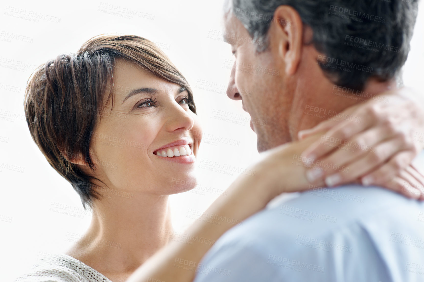 Buy stock photo Happy, hug and couple in studio with love, bonding and safety in marriage with affection. Smile, connection and woman embracing man for care, trust and greeting in relationship by white background.