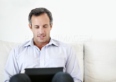 Buy stock photo Reading, freelancer and man with tablet on sofa for insurance coverage, email or space. Tech, mature and happy person with remote work, policy benefits and risk assessment for claims report at home