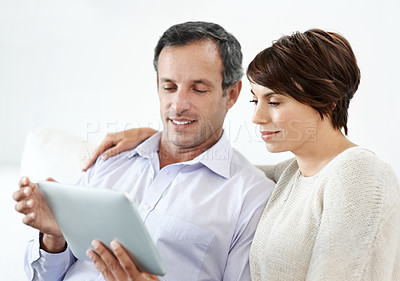 Buy stock photo Couple, relax and sofa with tablet in home for online browsing, research or network connection. Man, woman or chilling with smile on technology for website, streaming app or subscription in house