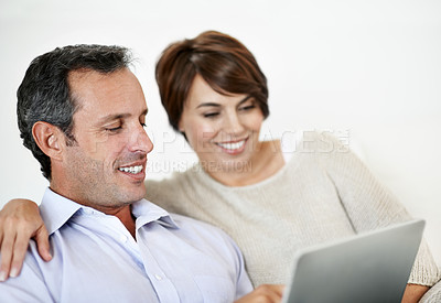 Buy stock photo Happy, man or couple in house with tablet, booking plan or trip decision on travel site. Smile, mature husband or wife in home with tech, vacation review or resort selection on holiday platform.