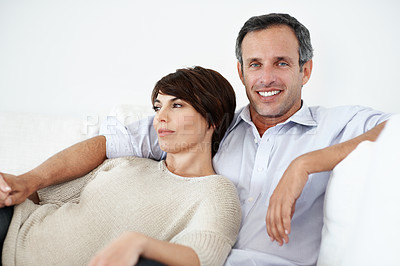 Buy stock photo Love, smile or couple on sofa with day off, partner bonding or cozy cuddle on weekend break. Portrait, mature man or woman in home with unwind, relax together or calm moment in romantic connection.