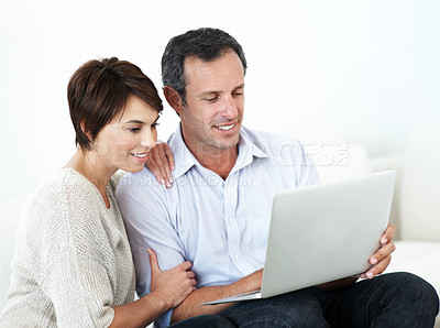 Buy stock photo Couple, laptop and happy together on home sofa for online connection, browsing and internet or space. Mature man, woman or tech in house living room for streaming, subscription or planning on website