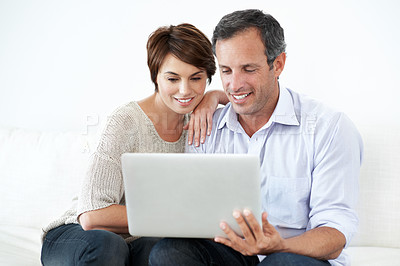Buy stock photo Couple, laptop and happy with internet on home sofa for online connection, browsing and smile. Mature man, woman and technology in house living room for streaming, subscription or planning on website