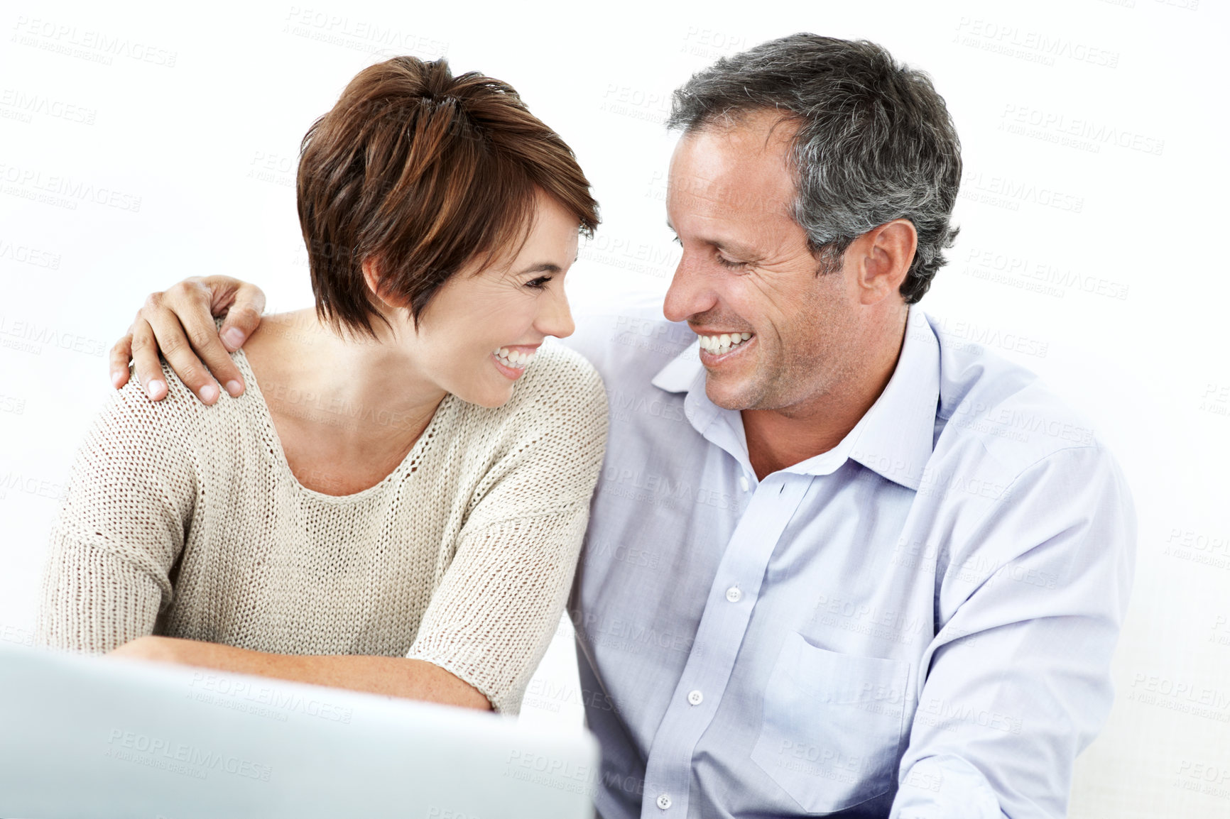 Buy stock photo Happy, couple and laughing with laptop in studio for comedy or entertainment on a white background. Man, woman or smile with humor on computer for funny joke, movie or online streaming together