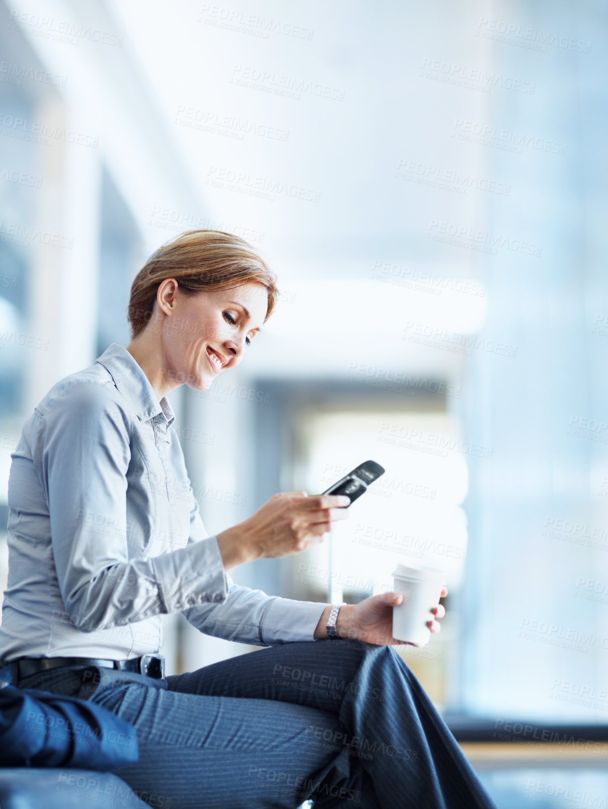Buy stock photo Woman, lawyer and reading in office with phone, legal research and evidence for court case. Smile, female attorney and coffee with mobile, witness statement and lawsuit information for investigation
