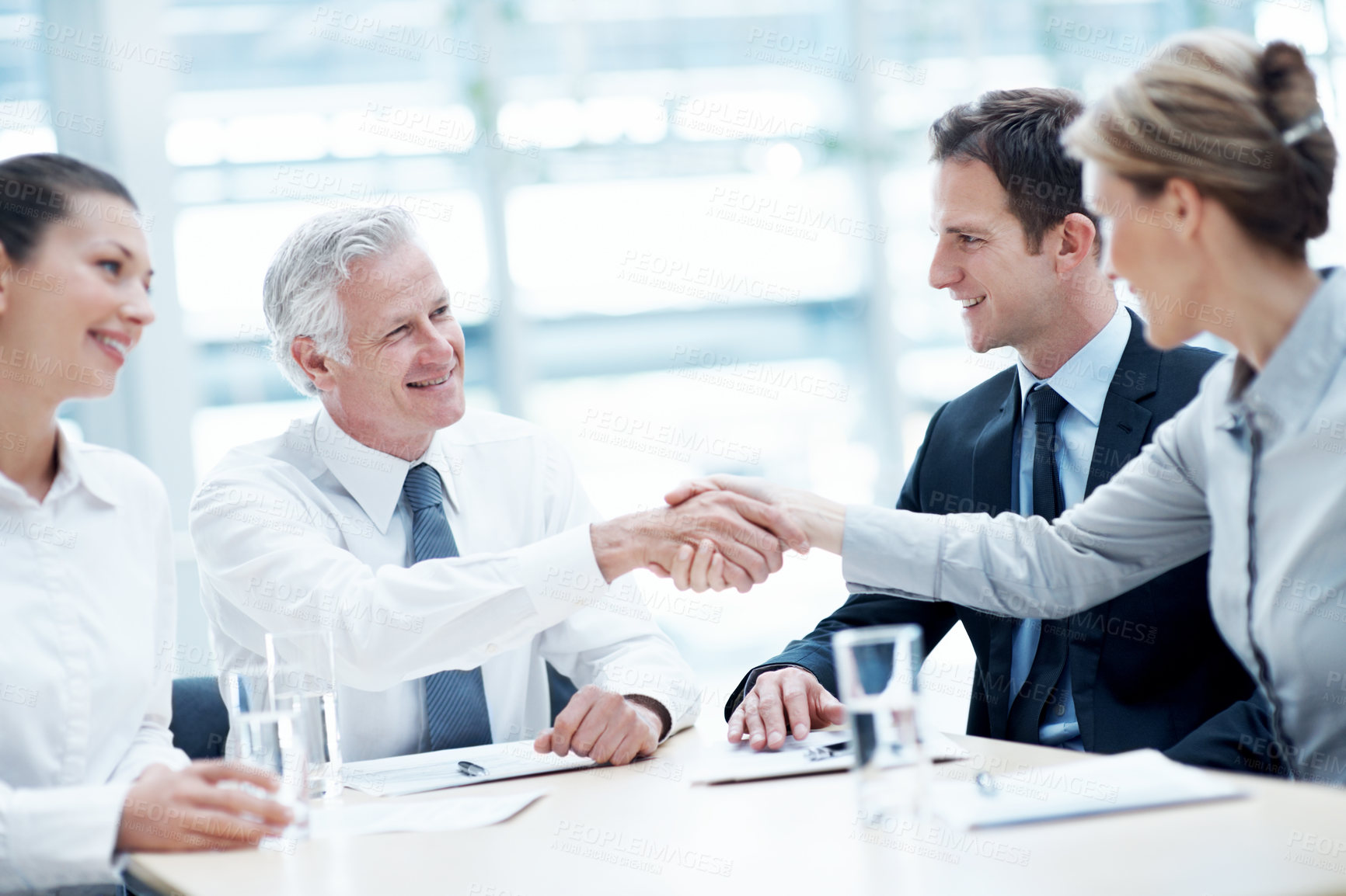 Buy stock photo Shaking hands, meeting and business people in office for deal, agreement or legal settlement. Team, discussion and attorneys with general counsel for handshake on court case, law or mediation process