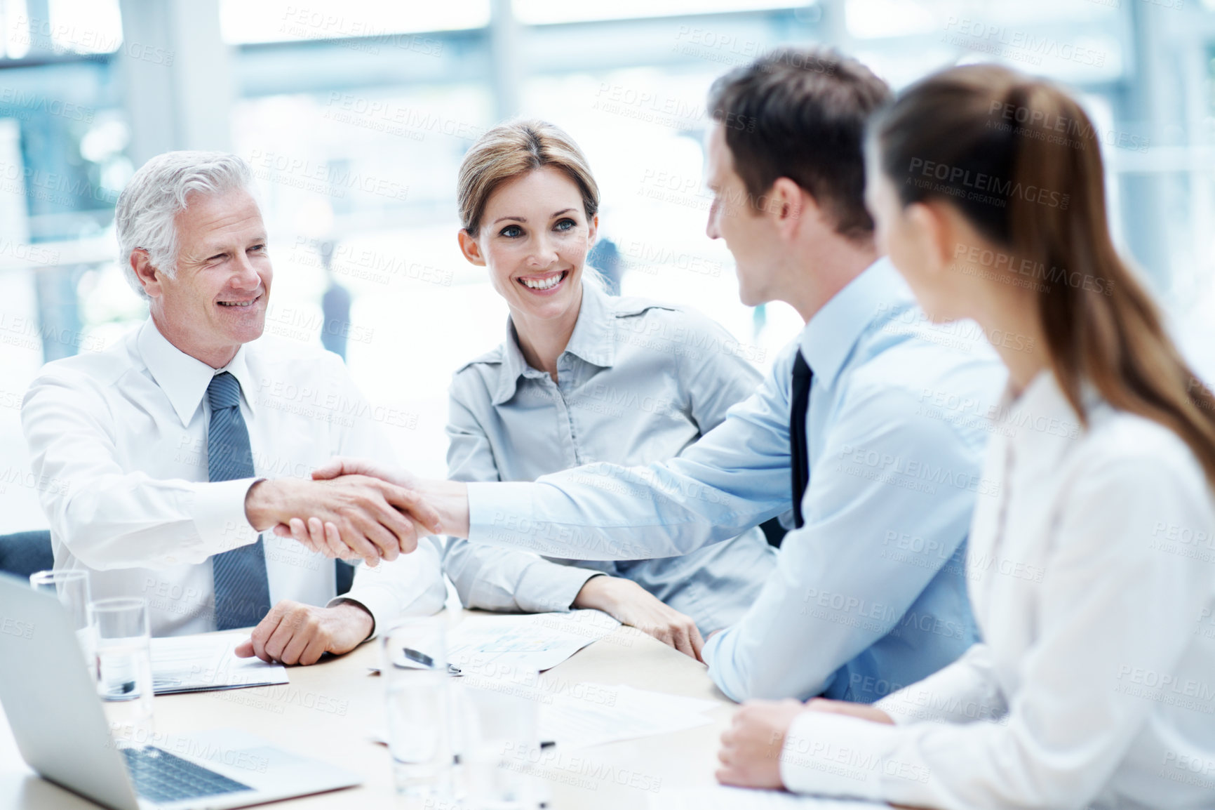 Buy stock photo Shaking hands, laptop and business people in office for deal, agreement or legal settlement. Team, meeting and attorneys with general counsel for handshake on court case, law or mediation process.