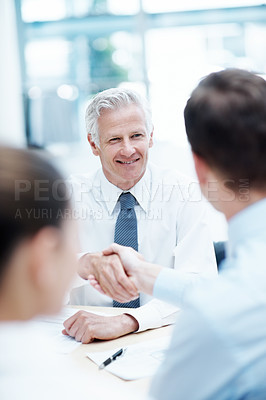Buy stock photo Handshake, meeting and businessman in office for agreement, deal or finance negotiation. Happy, discussion and financial advisor shaking hands with investor for partnership, contract or offer.