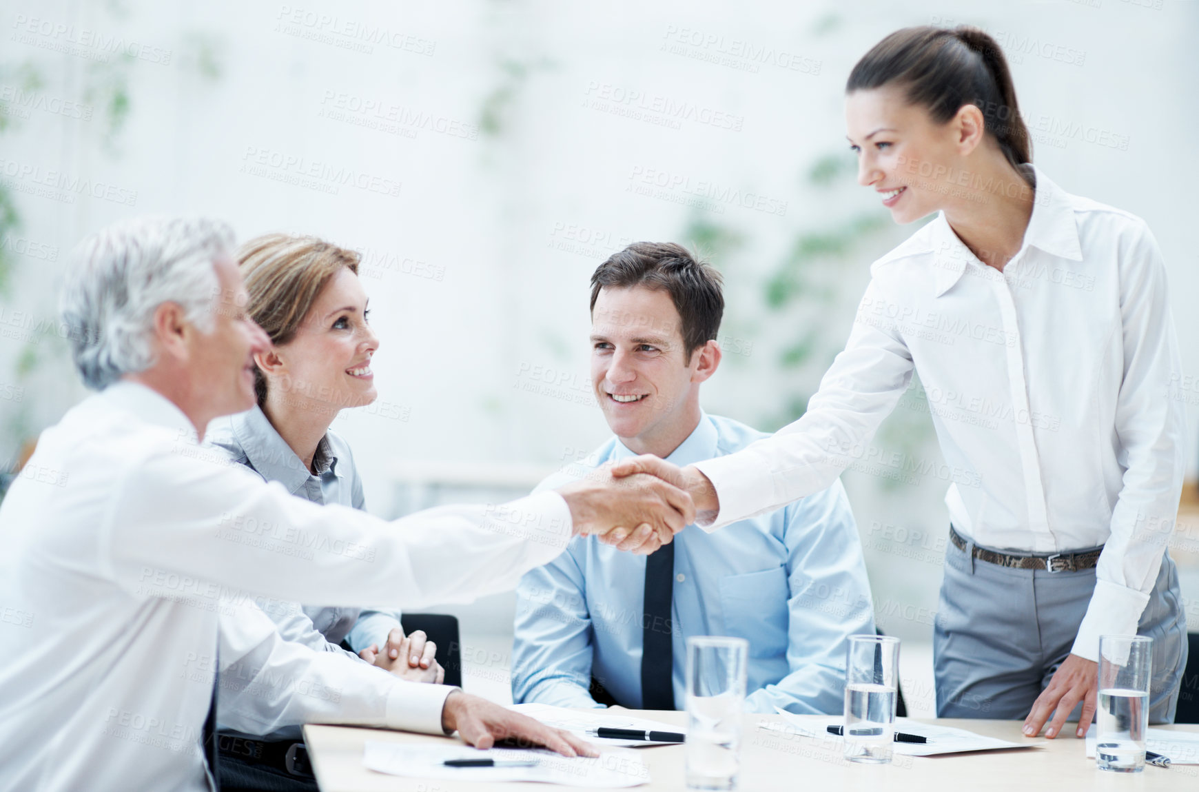 Buy stock photo Handshake, meeting and business people in office for deal, agreement or finance negotiation. Happy, discussion and financial advisor shaking hands with investor for partnership, contract or offer.