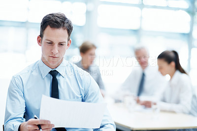 Buy stock photo Office, man and reading document in meeting for financial compliance, report or review information. Paperwork, team and business person with proposal, investment regulation and risk management